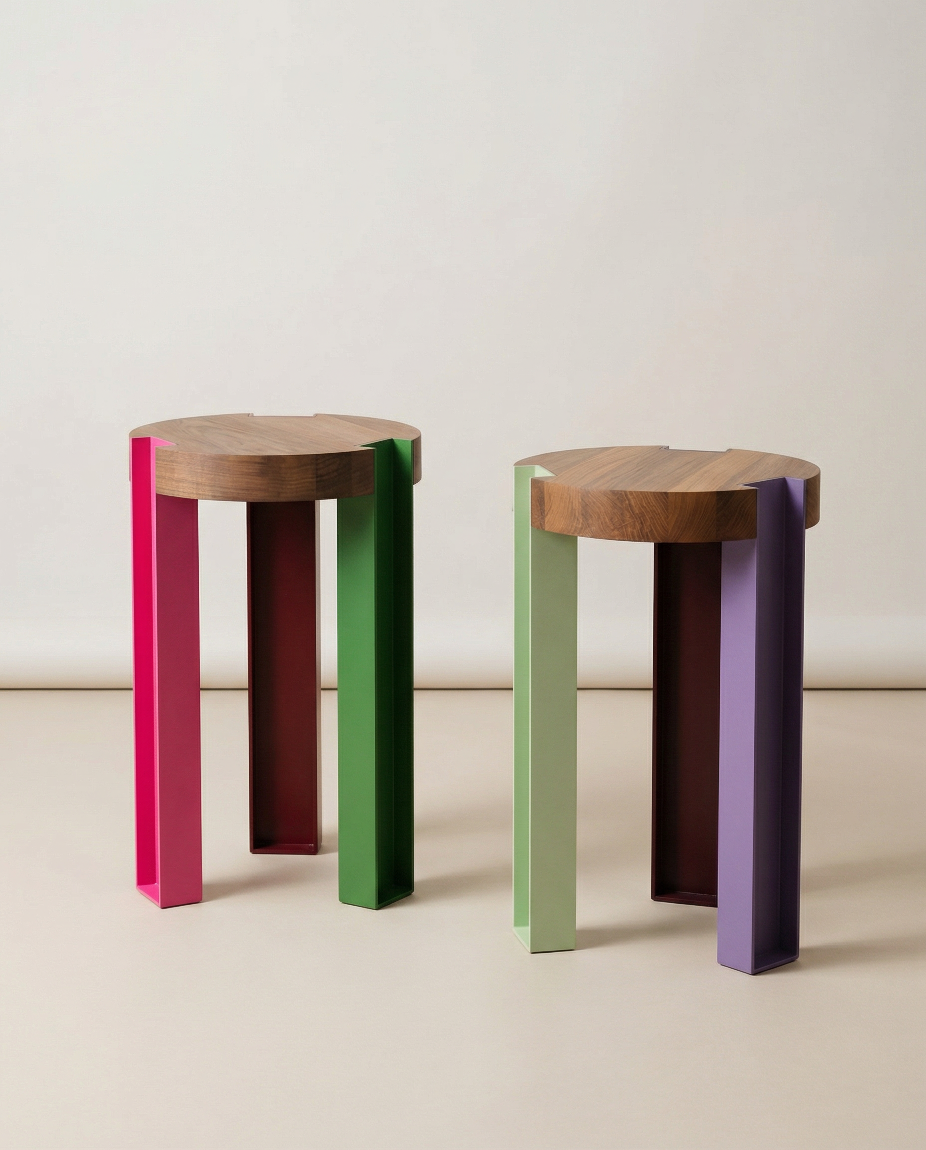 Two colorful stools with wooden tops on a plain background